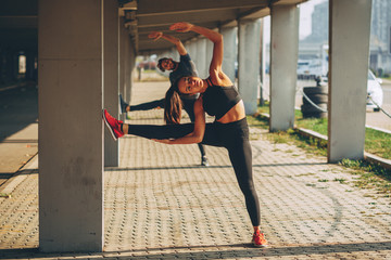 Young sports couple exercising in the urban environment