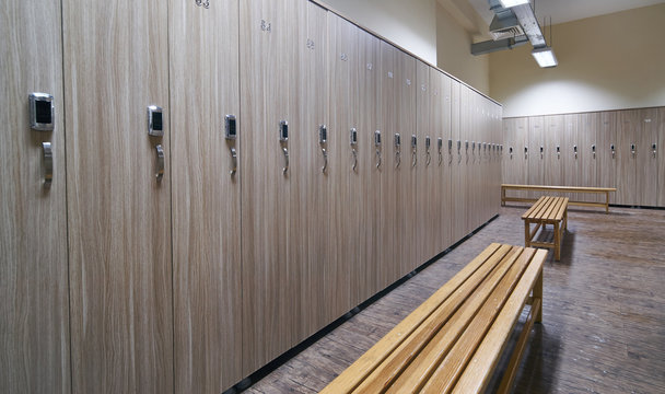 Locker Room With Wood Benches And Wooden Lockers In The Gym