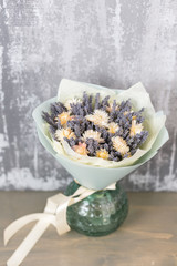 Bouquet of lavender and dry flowers. Colorful summer bunch of purple lavender and yellow chamomile flowers.