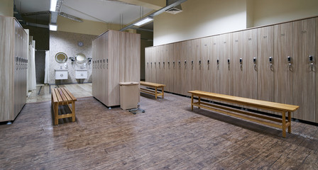 Locker room with wood benches and wooden lockers in the gym