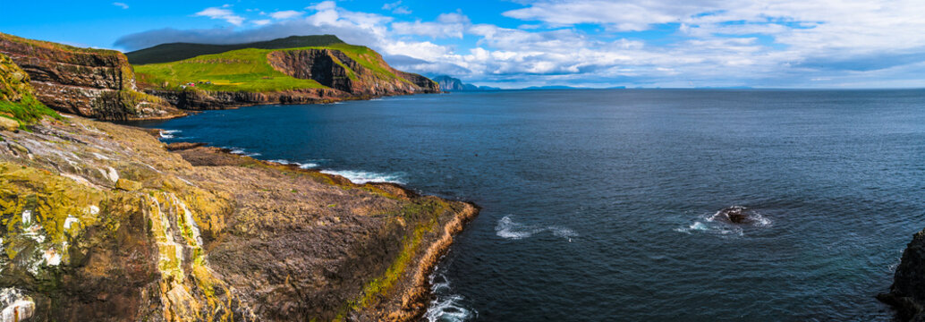Panoramic view of Mykines at Faroe islands and North Atlantic puffins