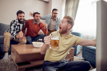 Group of friends watching sport together.