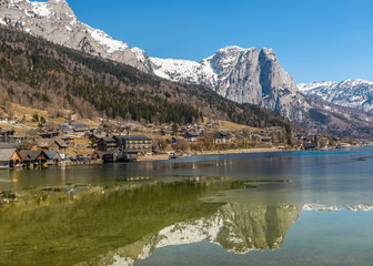 Sunny winter Alpine lake Grundlsee (Styria, Austria) with fantastic reflection on the water surface.