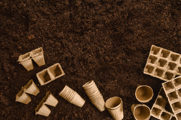 Gardening tools on fertile soil texture background seen from above, top view. Gardening or planting concept. Working in the spring garden.