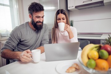 Couple having breakfast in kitchen