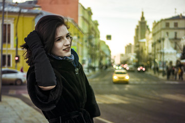 Fototapeta premium young gild walking in the europe street with traffic on background