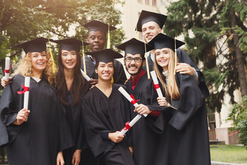 Graduates having a group hug