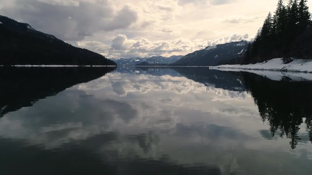Glassy Alpine Lake Water Cloud Mirror Low Drone Angle