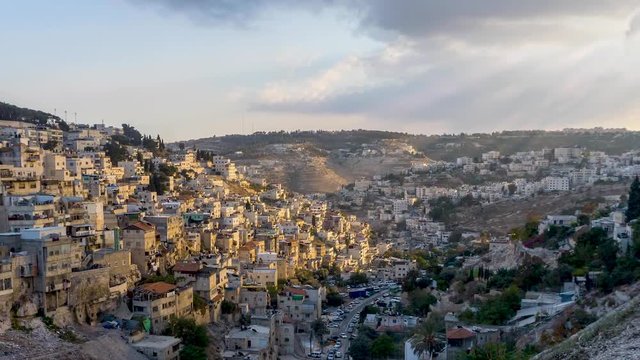 Zooming out to reveal a sparkling time lapse of the City of David in Jerusalem with sun rays lighting the biblical city