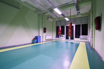 Interior of a spacious gym with punching bags