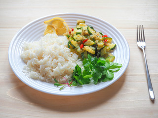 White rice and zucchini with vegetables. Vegetarian cuisine.
