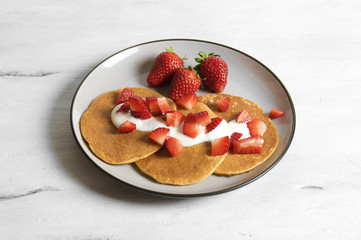 Healthy oat and banana pancake with yoghurt and strawberry 