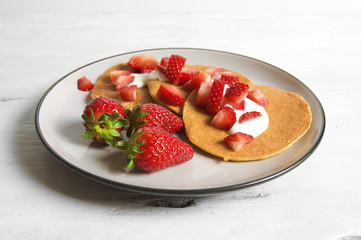 Healthy oat and banana pancake with yoghurt and strawberry 