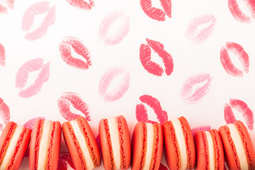 French macarons overhead arrangement on white background with red kisses front view in studio