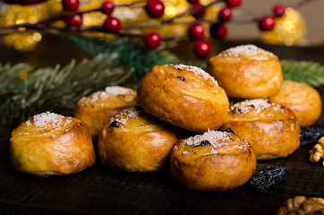 homemade cookies with sugar, New Year decorations, on a dark wooden background with a spruce branch