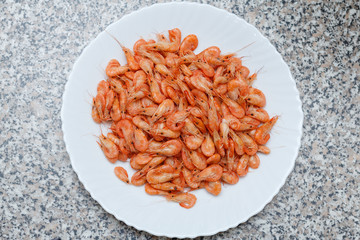 Shrimp. Shrimps lie on a plate. Boiled ready-to-eat shrimp. A large dish of small shrimps.