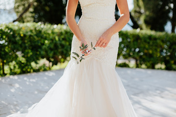 Bride in beautiful dress on beach with sea view