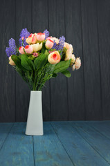 beautiful spring bouquet of roses and lavender on a wooden