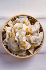 Plate of pierogi or varenyky, vareniki, Dumplings, filled with beef meat and served with fried onion. Pyrohy - dumplings with filling. View from above, top, overhead