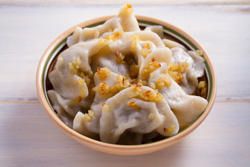 Plate of pierogi or varenyky, vareniki, Dumplings, filled with beef meat and served with fried onion. Pyrohy - dumplings with filling