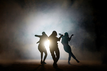 Group of young female dancers on the street at night. common interests. favourite pastime. dancing together