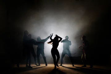 Gordijnen teenagers making dancing moves isoleted on the black background. like moves. fancy of dancing © alfa27