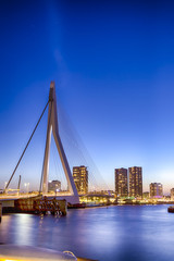 Fototapeta na wymiar Travel Concepts. View of Unique and Beautiful Erasmus Bridge in Rotterdam. Shot During Blue Hour