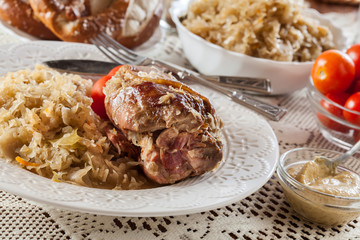 Pork knuckle with fried sauerkraut and tomatoes