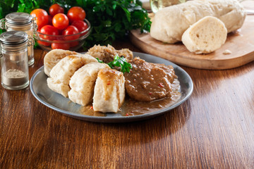 Pork loin in gravy with bread dumplings and sauerkraut