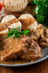 Pork loin in gravy with bread dumplings and sauerkraut