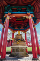 Statue of seated great Buddhist teacher of the monastery of Nalanda in pagoda near Temple Golden...