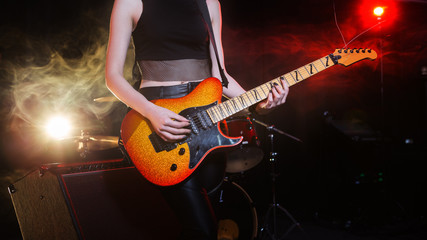 Obraz na płótnie Canvas guitarist girl playing. Rock concert.