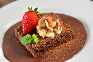 Brownie with chocolate sauce and strawberry