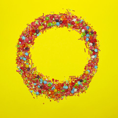Abstract Colorful Background. Colorful Candies On Yellow Background With A Lot Of Copy Space For Text.Many Multicolored Candy Sweets On Yellow Background.Closeup Of Multicolored Small Candies.
