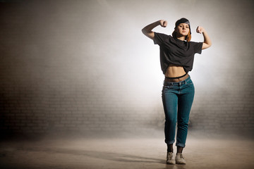 young street female demonstrating her muscles.build muscles.clenched fists