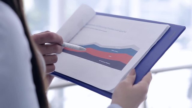 Close Up Of Female And Male Hands Pointing At Business Document While Discussing It