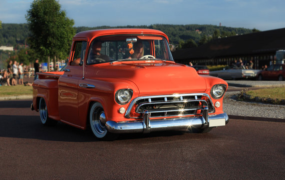 Old american chevrolet pickup truck on the road. Vintage car orange truck  - retro style. 
