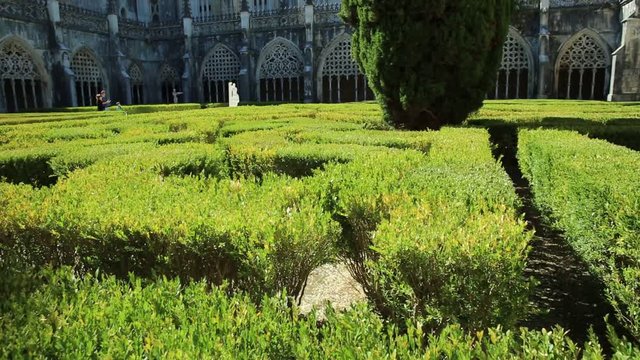 Portugal, Batalha. Courtyard of Batalha Monastery or Saint Mary of the Victory Unesco Heritage and one of the best examples of Gothic architecture in Portugal, mixed with Manueline style. Blue sky.