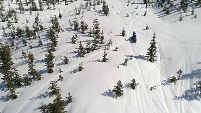 Man Climbing Hill on Snowmobile Sunshine Blue Sky Aerial