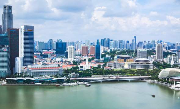 Beautiful super wide-angle summer aerial view of Singapore, with skyline, bay and scenery beyond the city, seen from the observation deck
