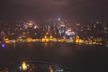 Fototapeta na wymiar Beautiful super wide-angle night aerial view of Shanghai, China with Waitan, The Bund and scenery beyond the city, seen from the observation deck of Oriental Pearl TV Tower
