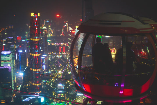 Beautiful wide-angle night aerial view of Guangzhou Zhujiang New Town financial district, Guangdong, China with skyline and scenery beyond the city, seen from the observation deck of Canton Tower
