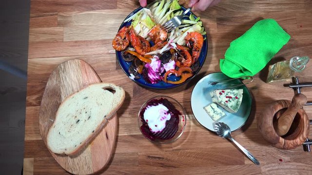 Top view prepare serving plate with shrimps, andive, beet salad and moldy cheese.