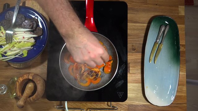 Top view food preparation Shrimp and violet potatoes to the pan on the stove with induction
