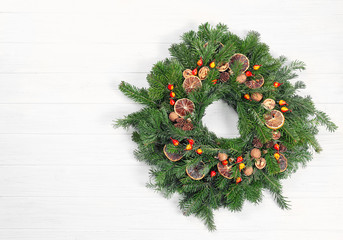 Beautiful Christmas wreath made by professional florist on white wooden background