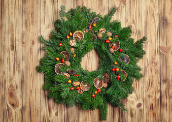 Beautiful Christmas wreath made by professional florist on wooden background