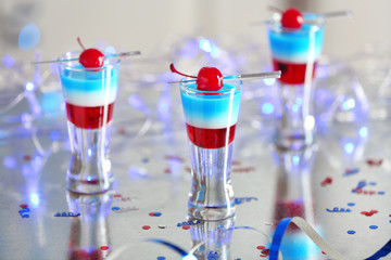 Layered cocktails in colors of American flag on table