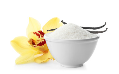 Vanilla sugar in bowl with flower and sticks on white background