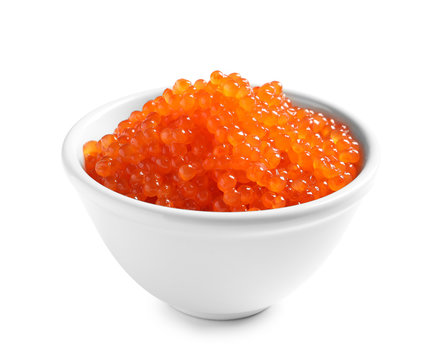 Bowl with delicious red caviar on white background