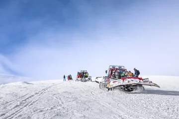 Türaufkleber Tourists on ski piste at snowy resort. Winter vacation © Africa Studio